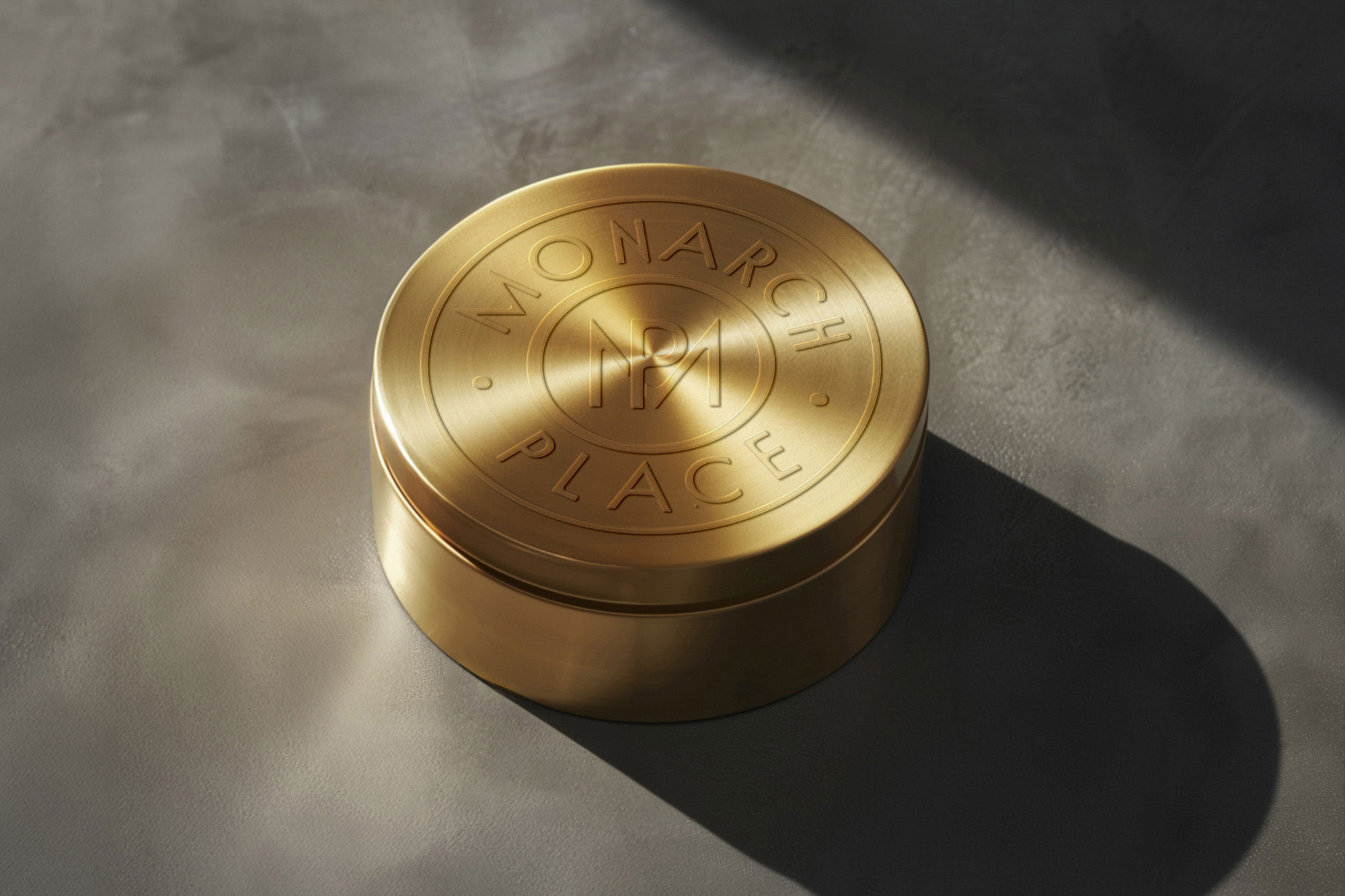 Monarch-Place-Gold-container-on-luxury-background_updated